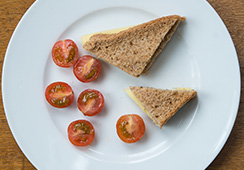 Cheese sandwich (¾ slice wholemeal bread), 3 cherry tomatoes halved