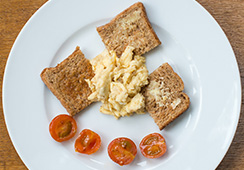 ¾ slice wholemeal toast, 3 tablespoons scrambled egg, 2 cherry tomatoes halved
